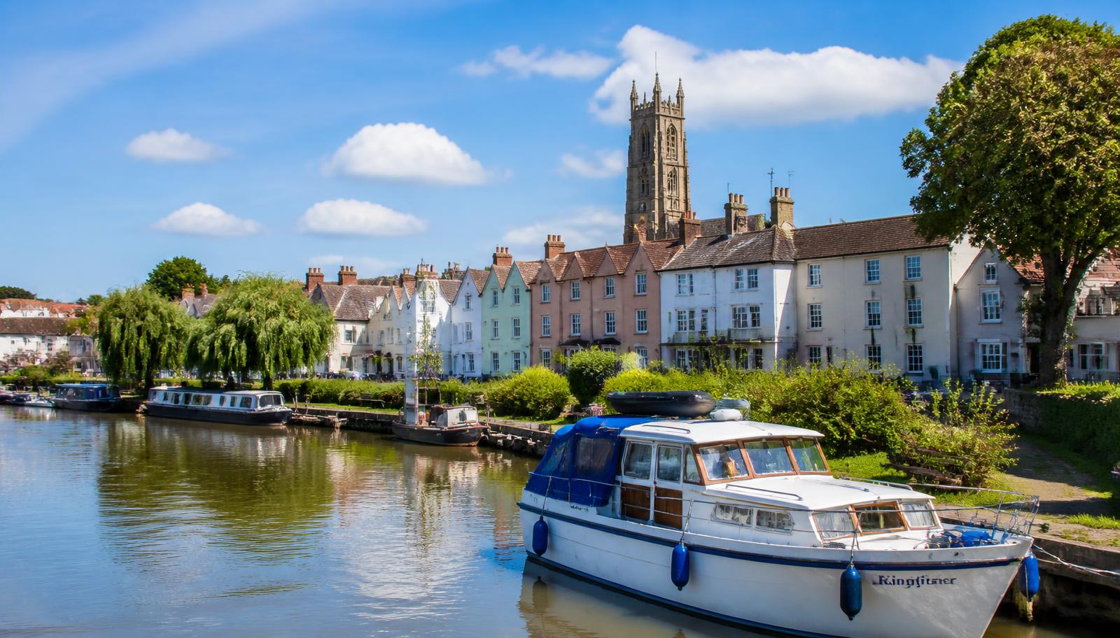 Upton upon Severn riverside with moored boats and the pepperpot church tower